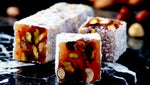 Indulge in the exquisite blend of flavors with Sultan's Premium Turkish Delight - Mix Nuts Covered Coconut. Each delightful piece is adorned with a variety of nuts, including almonds, walnuts, and hazelnuts, all enrobed in a luscious coconut coating. Elevate your Ramadan celebrations with this luxurious treat, perfect for sharing with loved ones. Order now for delivery in South Florida and across the US.  