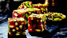 Indulge in the exquisite taste of Sulan's Premium Turkish Delight - Pomegranate Flavor with Pistachio. Each luxurious piece offers a tantalizing fusion of tangy pomegranate and crunchy pistachios, creating a delightful burst of flavor with every bite. Elevate your Ramadan celebrations with this luxurious delicacy, meticulously crafted to delight your senses. Order now for delivery in South Florida and across the US.  